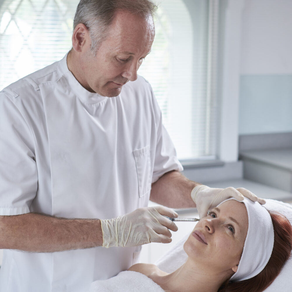 Dr Mervyn Patterson administering botox