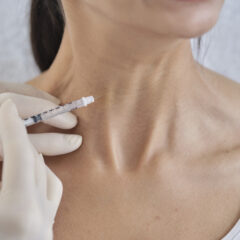 Lady having neck injected with Botox